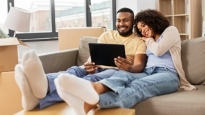 Happy couple looking at ipad together